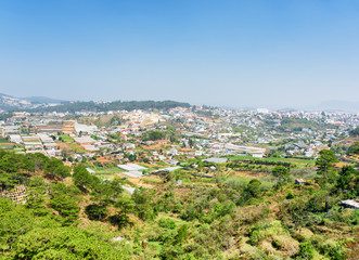Fototapeta na wymiar View of the valley of agricultural lands and Da Lat city (Dalat)