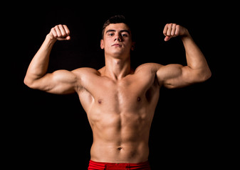 Fototapeta na wymiar Portrait of boxer posing studio in gloves.