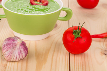 Bowl of tomato soup on wood.