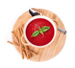 Bowl of tomato soup on board.