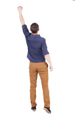 Back view of  man in checkered shirt Raised his fist up in victo
