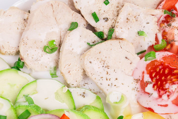 Warm meat salad with vegetables.