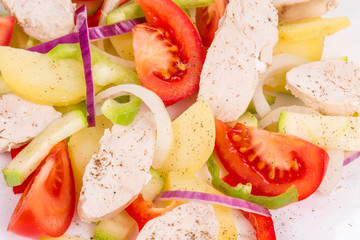 Warm meat salad with vegetables.