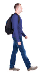 Naklejka premium back view of walking man with backpack.