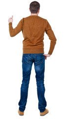 Back view of man in blue pullover shows thumbs up.