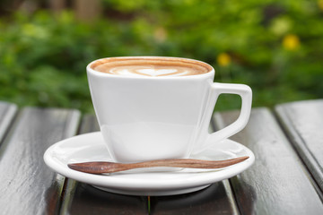 A Cup of latte coffee on wooden table