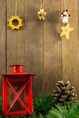 christmas decoration with red candlestick and brown pine cone on