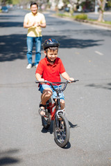 Fototapeta na wymiar Boy riding a bicycle