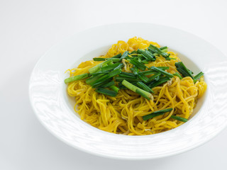 Fried noodles with leek in white plate