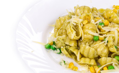 Pasta shells with vegetables on white plate