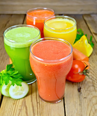 Juice tomato and vegetable in glassful on board
