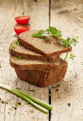 Slices of bread with a knife on a wooden board