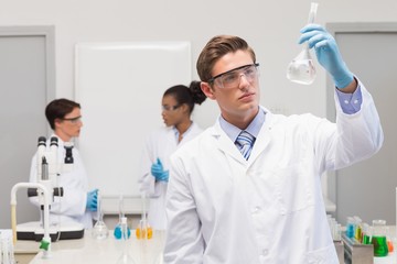 Scientist looking at white precipitate