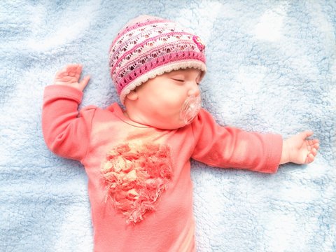 Baby Girl Sleeping On A Blue Blanket