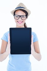 Smiling woman showing her tablet looking at camera