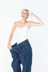 Smiling woman wearing too big jeans