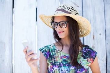 Smiling beautiful brunette using her phone