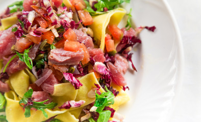Homemade tagliatelle with fresh tuna served with cherry tomatoes