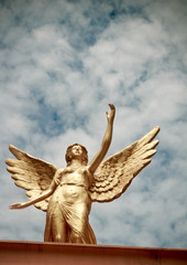 Winged angel statue isolated on sky