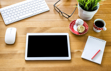 Tablet computer with cup of coffee