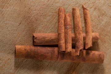 whole cinnamon sticks on wooden background