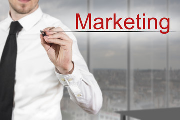 businessman writing marketing in the air