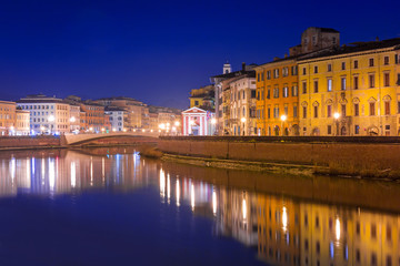 City center of Pisa with reflection in Arno river, Italy