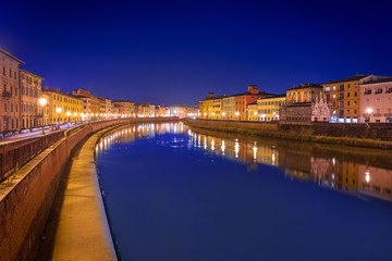 City center of Pisa with reflection in Arno river, Italy