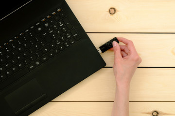 Hand inserting usb memory stick to laptop computer
