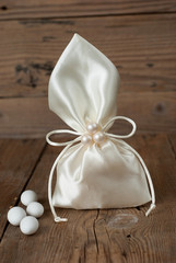 Fabric pouch wedding favor on old wooden table