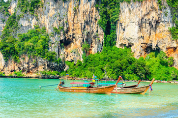 Plakat Amazing Railay Beach with mogotes, long tail boat andred kayaks,