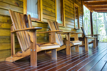 Fototapeta na wymiar Row of wooden chairs on terrace
