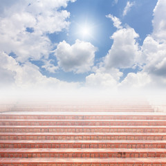 Red brick staircase and blue sky with sun