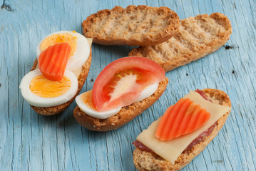Rusks sandwich on old wooden table