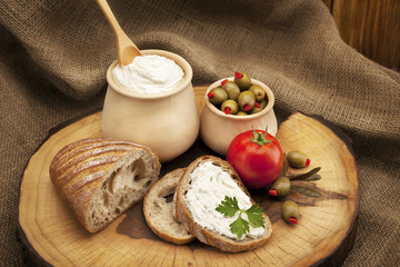 Delicious organic cream milk cheese, olives and home-made bread