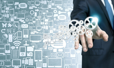 Businessman activating gears mechanism