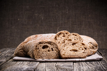 Tasty bread on wooden background.