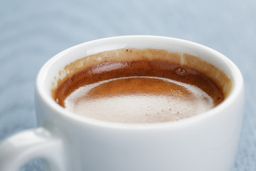 cup of fresh espresso on vintage blue table