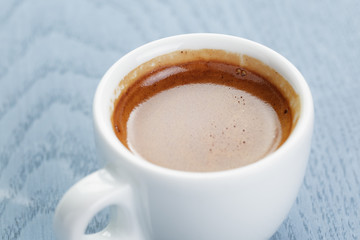cup of fresh espresso on vintage blue table