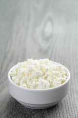 cottage cheese in white bowl on old table