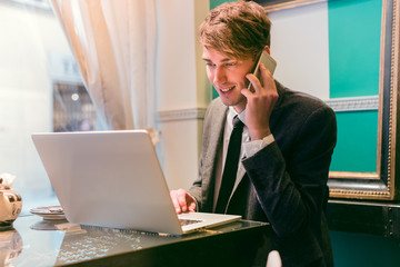 Business man with mobile phone and laptop