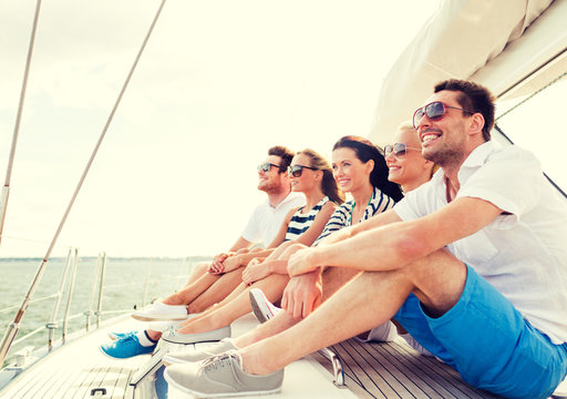 Smiling Friends Sitting On Yacht Deck