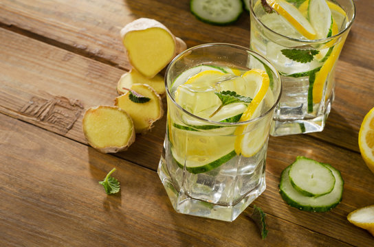 Fresh water with lemon, mint , ginger and cucumber  on a wooden