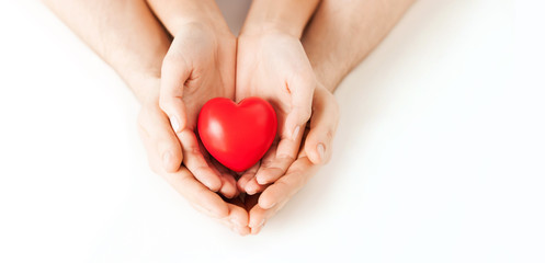 couple hands holding red heart