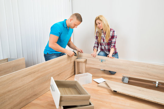 Couple Assembling Wooden Furniture