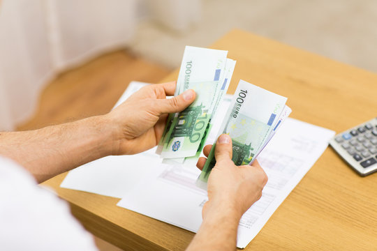 Close Up Of Man Hands Counting Money At Home