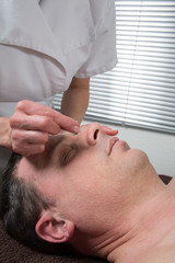 Fototapeta na wymiar Man Undergoing Acupuncture Treatment