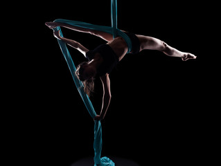 Young woman gymnast with blue gymnastic ribbon