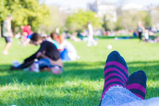 colored socks of a teenager who is resting in a park