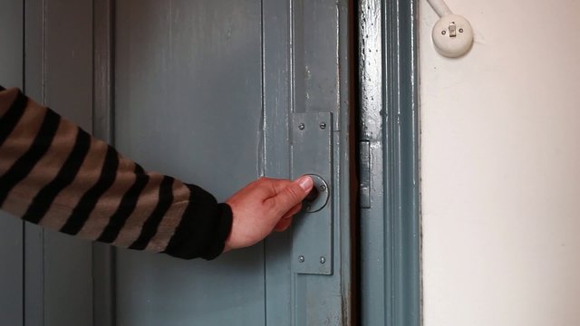 Detail of hands closing a door